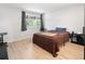 Bright bedroom with hardwood floors, a large window, and neutral decor at 1264 S Crystal Way, Aurora, CO 80012