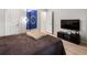 Bedroom with a large bed, TV, and Star Trek flag, creating a comfortable and inviting space at 1264 S Crystal Way, Aurora, CO 80012