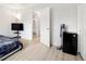Bedroom with a TV and an open doorway leading to a well-lit bathroom at 1264 S Crystal Way, Aurora, CO 80012