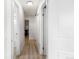 Hallway with white walls and wood floors, leading to various rooms at 1264 S Crystal Way, Aurora, CO 80012