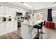 Modern kitchen features white cabinets, stainless steel appliances, and a large island at 1264 S Crystal Way, Aurora, CO 80012