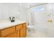 Clean bathroom featuring a vanity, toilet, and shower with a window at 10535 Garfield St, Thornton, CO 80233