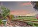 Landscaped backyard featuring a garden bed, wooden fence, and view of nearby houses at 10554 Atwood Cir, Littleton, CO 80130