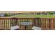 A cozy balcony with a small table and chairs overlooks scenic views at 10554 Atwood Cir, Littleton, CO 80130