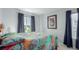Comfortable bedroom featuring a colorful quilt, picture window, and neutral decor at 10554 Atwood Cir, Littleton, CO 80130