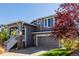 Two-story home featuring a front porch, well-maintained landscaping, and a two-car garage at 10554 Atwood Cir, Littleton, CO 80130