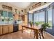 Bright kitchen with wood cabinets, modern appliances, and eat-in area with a large window at 10554 Atwood Cir, Littleton, CO 80130