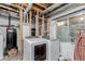 Unfinished basement laundry area with modern washer and dryer appliances at 10554 Atwood Cir, Littleton, CO 80130