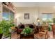 Inviting living room with a comfortable sofa, plants, and large windows for natural light at 10554 Atwood Cir, Littleton, CO 80130