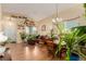 Bright open-concept living space with plants, hardwood floors, and natural light at 10554 Atwood Cir, Littleton, CO 80130