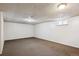 Expansive basement space with carpeted floor, perfect for storage at 15440 E Oberlin Pl, Aurora, CO 80013