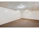 Large basement area with carpeted flooring and two small windows at 15440 E Oberlin Pl, Aurora, CO 80013
