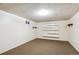 Unfinished basement area with carpet and shelves, ready for customization at 15440 E Oberlin Pl, Aurora, CO 80013