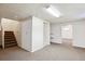 Spacious basement with carpeted floors, stairs and two open closets at 15440 E Oberlin Pl, Aurora, CO 80013