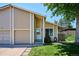 Inviting two-story home with an attached garage, showcasing a well-maintained lawn at 15440 E Oberlin Pl, Aurora, CO 80013