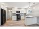 Modern kitchen features sleek white cabinets, contemporary countertops, and stainless steel appliances at 15440 E Oberlin Pl, Aurora, CO 80013