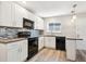 Well-equipped kitchen features white cabinetry, stylish backsplash, and modern appliances at 15440 E Oberlin Pl, Aurora, CO 80013