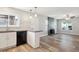 Open-concept layout blending the kitchen and living room, featuring a modern fireplace at 15440 E Oberlin Pl, Aurora, CO 80013