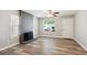 Comfortable living area with a striking brick fireplace, and light wood-look flooring at 15440 E Oberlin Pl, Aurora, CO 80013