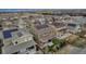 Aerial view of home featuring solar panels, green lawn, and covered patio at 697 Sundance Cir, Erie, CO 80516