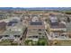 An aerial view of a housing development featuring houses with solar panels and a mountain range in the distance at 697 Sundance Cir, Erie, CO 80516