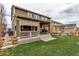 Exterior of home showcases a covered patio, nice lawn and access to backyard at 697 Sundance Cir, Erie, CO 80516