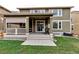 Back of home showcasing covered patio, nice lawn and easy access to interior at 697 Sundance Cir, Erie, CO 80516