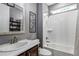 Bathroom featuring double sink vanity, marble countertop and shower over bath at 697 Sundance Cir, Erie, CO 80516