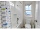 Bright bathroom features a shower and tub combination with fish themed shower curtain and a mountain view at 697 Sundance Cir, Erie, CO 80516