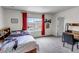 Well lit bedroom with carpet, work space, decorative shelf, and view from the window at 697 Sundance Cir, Erie, CO 80516