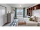 Cozy bedroom with a charming chandelier, built-in shelves and a picturesque view from the window at 697 Sundance Cir, Erie, CO 80516
