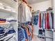 Walk-in closet with ample shelving and organized storage space for clothes and shoes at 697 Sundance Cir, Erie, CO 80516