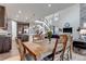Open-concept dining room featuring a wooden table and view of the kitchen and staircase at 697 Sundance Cir, Erie, CO 80516