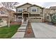 Inviting two-story home featuring a well-manicured lawn, concrete driveway, and a welcoming front porch at 697 Sundance Cir, Erie, CO 80516