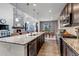 Spacious kitchen with a large center island, granite countertops, and an open view into the living area at 697 Sundance Cir, Erie, CO 80516