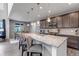 Beautiful kitchen featuring a center island with seating, dark wood cabinets, and stainless steel appliances at 697 Sundance Cir, Erie, CO 80516