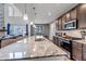 Bright kitchen featuring granite countertops, stainless steel appliances, and an open layout to the living room at 697 Sundance Cir, Erie, CO 80516