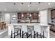 Stylish kitchen with granite countertops, a large island with seating, and dark wood cabinets at 697 Sundance Cir, Erie, CO 80516