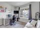 Bright office space with a large window, white sofa, desk, and shelving at 697 Sundance Cir, Erie, CO 80516