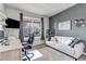 Home office space with a large window, white sofa, and desk area with ample light at 697 Sundance Cir, Erie, CO 80516