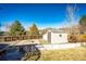 A backyard with a storage shed, brick-paved area, privacy fence, and a serene outdoor retreat at 11 Gordon Dr, Castle Rock, CO 80104