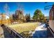 Spacious backyard featuring a large grass area, mature trees, and privacy fence, perfect for outdoor entertaining at 11 Gordon Dr, Castle Rock, CO 80104