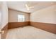 A bright bedroom with neutral carpet features wainscoting and a ceiling fan for added comfort at 11 Gordon Dr, Castle Rock, CO 80104