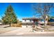 Desirable home with a two-car garage, lush trees, and a well-maintained front yard at 11 Gordon Dr, Castle Rock, CO 80104