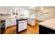 Bright kitchen with white cabinets, hardwood floors, and a center island at 11 Gordon Dr, Castle Rock, CO 80104