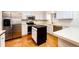 Bright kitchen features stainless steel appliances, white cabinets, and a center island, perfect for cooking and entertaining at 11 Gordon Dr, Castle Rock, CO 80104
