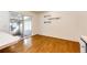 Bright living area with wood flooring, a sliding door to an outdoor patio, and minimalist decor at 11 Gordon Dr, Castle Rock, CO 80104