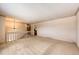 Open living room with neutral carpet, chandelier and staircase access at 11 Gordon Dr, Castle Rock, CO 80104