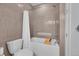 Neutral tiled bathroom with a shower-tub, a shower curtain, and modern fixtures at 3574 Corsica Way, Castle Rock, CO 80109