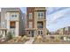 Modern three-story home with stone accents, a small balcony, and manicured landscaping in a vibrant neighborhood at 3574 Corsica Way, Castle Rock, CO 80109